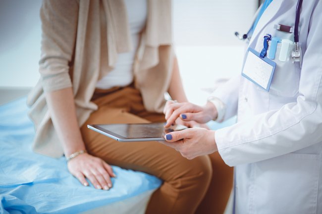 Doctor giving prescription to the patient